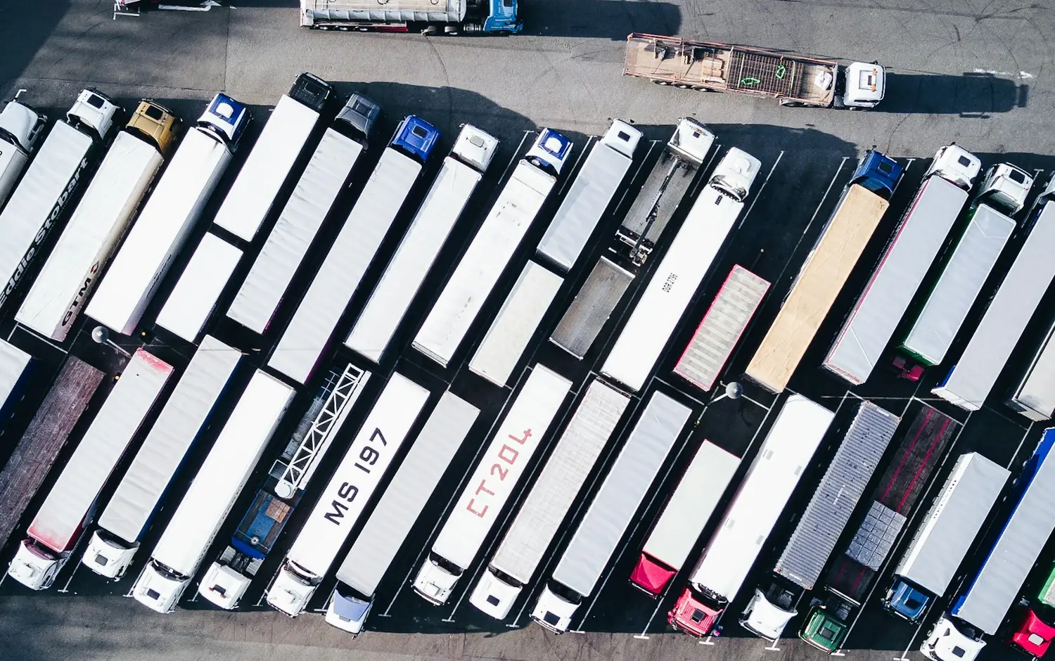 Articulated trucks parked at a freight terminal